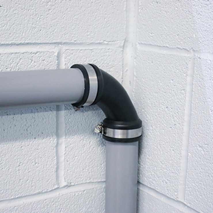PlumbQwik Elbow Coupling connected onto pipes